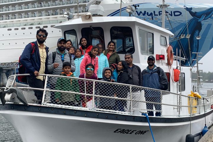 a family taking a pic on a boat in Ketchiken